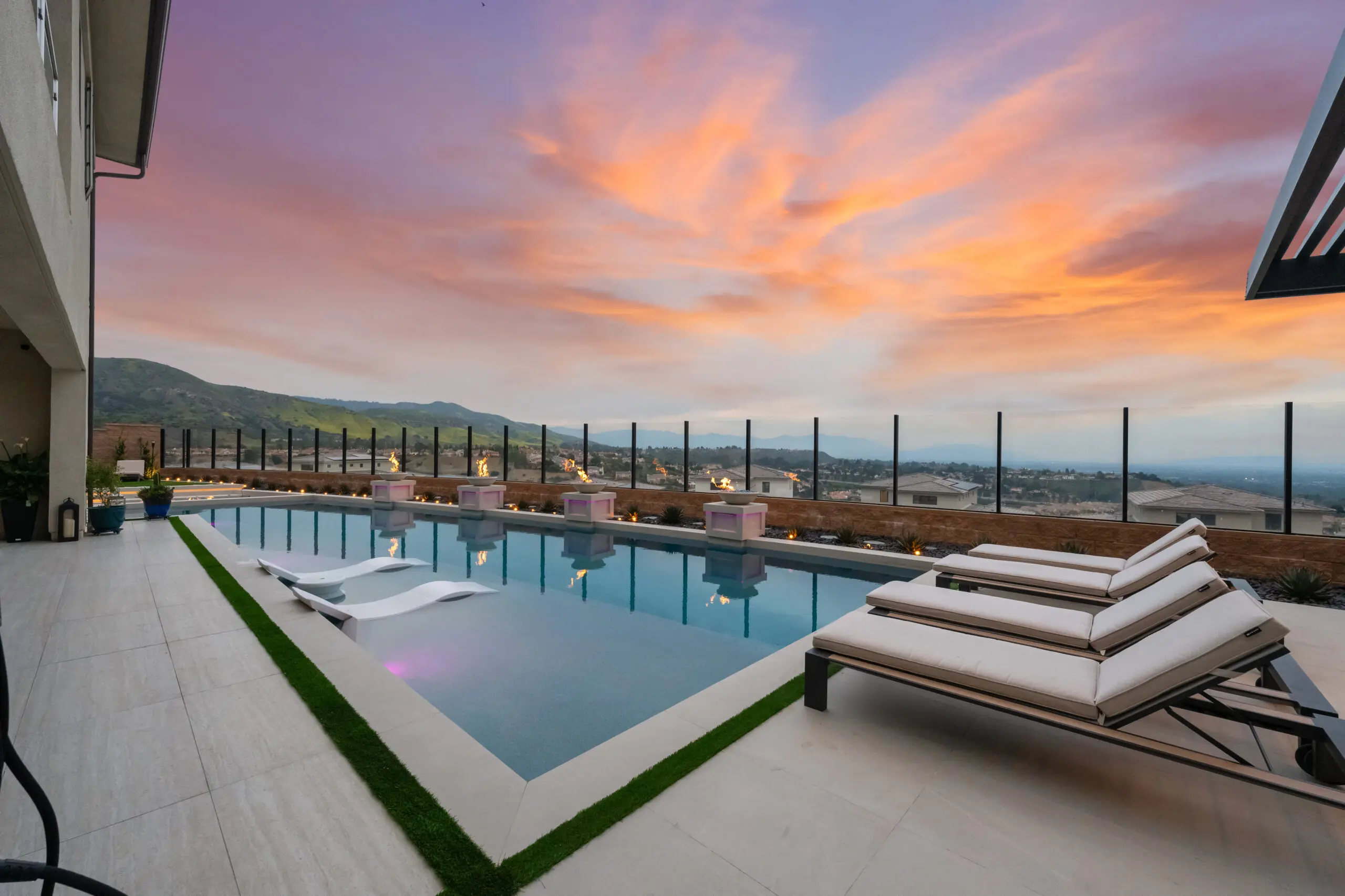 Luxury pool builders Orange County - hillside infinity edge pool with panoramic view and lounge deck