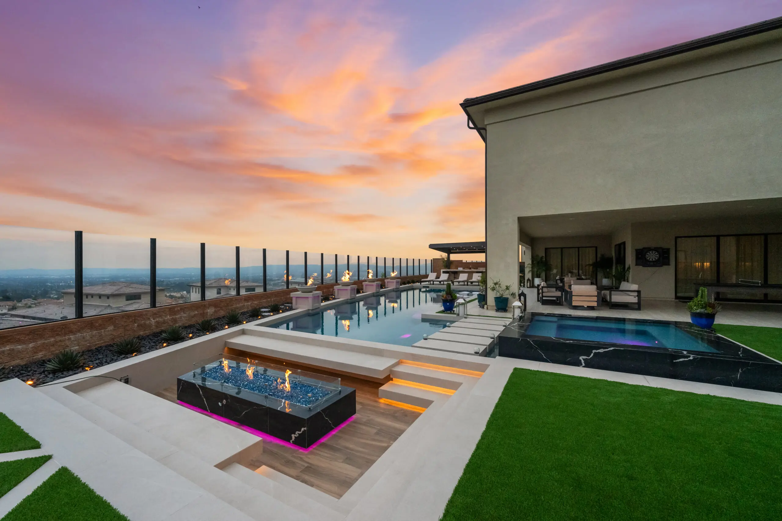 Swimming pool contractors Orange County CA - luxury pool, spa, and outdoor living space at sunset